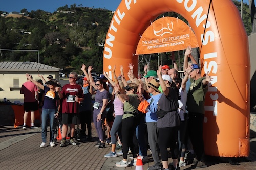 A group of run/walk participants under the start/finish arch