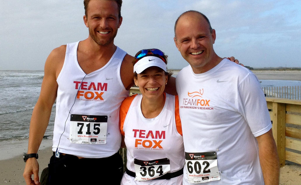 Three Team Fox athletes posing for camera on the beach.
