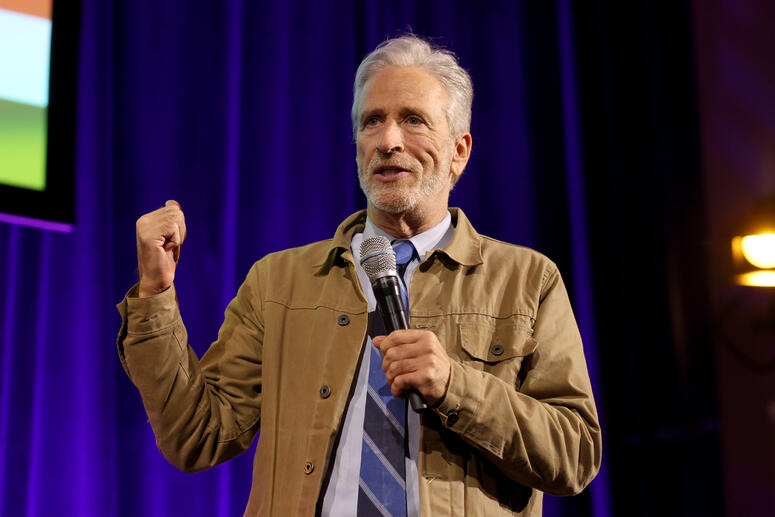 Jon Stewart performs onstage. 