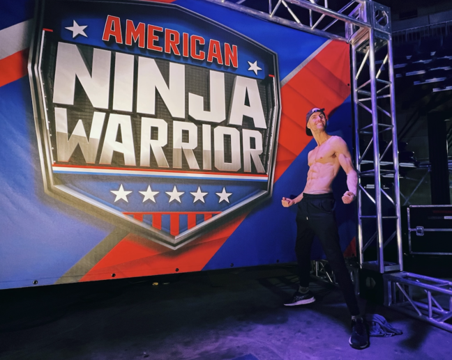 Man and American Ninja Warrior sign