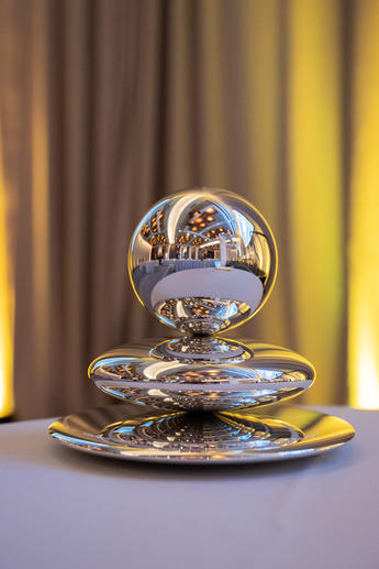 Silver, round award for the Pritzker Prize