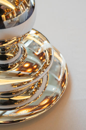 Round, silver award engraved with The Michael. J. Fox Foundation and The Robert A Pritzker Prize wording