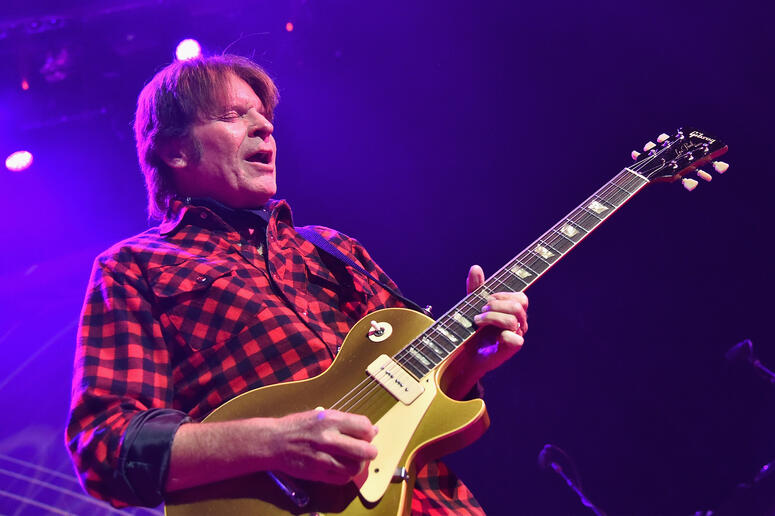 man with guitar onstage