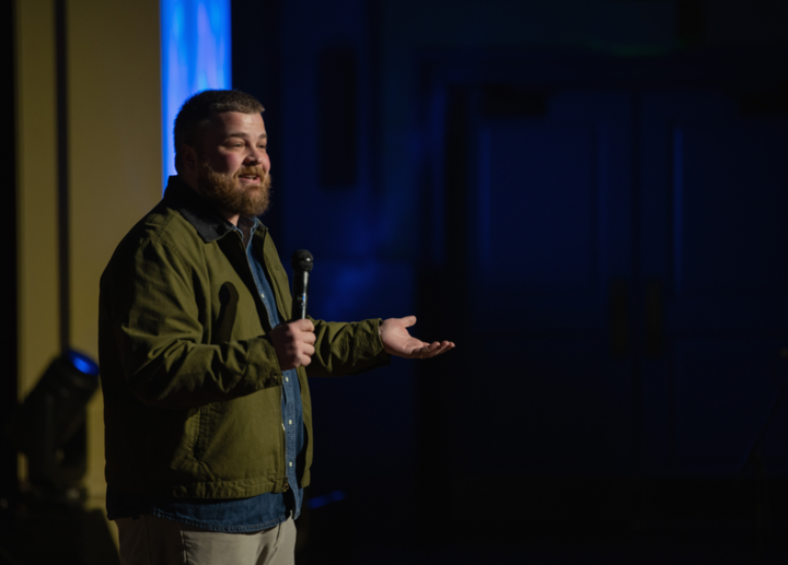 Comedian Aaron Weber performing on stage at the 2026 "A Country Thing Happened on the Way to Cure Parkinson's" fundraiser. 