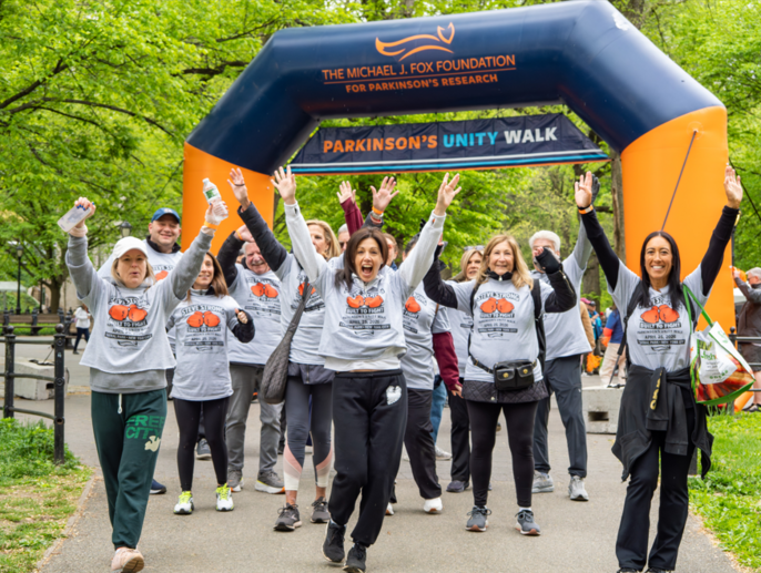 A group celebrates at the finish line of the 2026 Parkinson's Unity Walk.