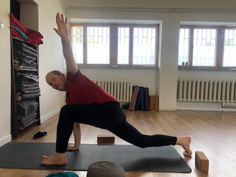 Wojciech Wasilewski practicing a yoga pose.