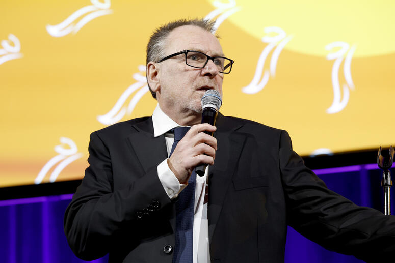 Colin Quinn performing onstage. 