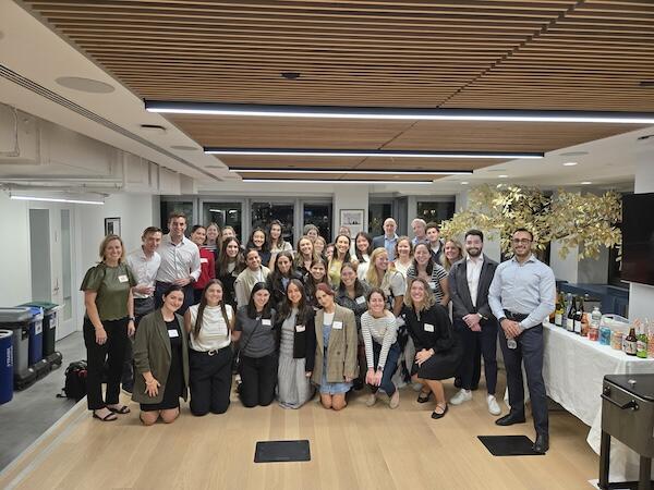 A group of young professionals in a group at an office event space