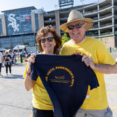 Couple at event holding Cure Parkinson's t-shirt 