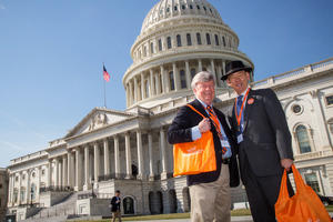 Two male advocates in front of the United States Capitol building at the Parkinson's Policy Forum.