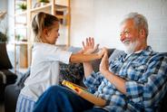 Grandfather and granddaughter laughing together