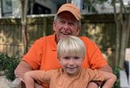 Chip holds his grandson, Teddy. 