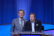 Harvey seated next to 'Jeopardy!' show host Ken Jennings. 