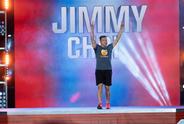 Jimmy Choi with his hands in the air cheering, while walking on to the American Ninja Warrior course.