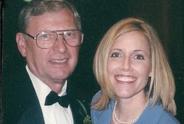 Man and woman smiling at camera.
