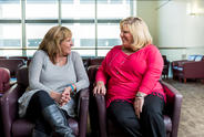 Two friends sitting in a doctor's office.