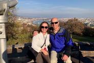Two people smiling at the camera outside.