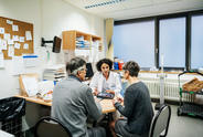 Three people talking at a clinic