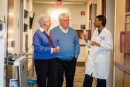 Parkinson's patient and care partner meet with doctor