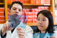 Two researchers in lab looking at samples