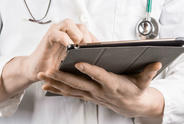 Doctor with tablet.