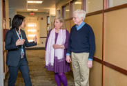 Three people talking at a clinic