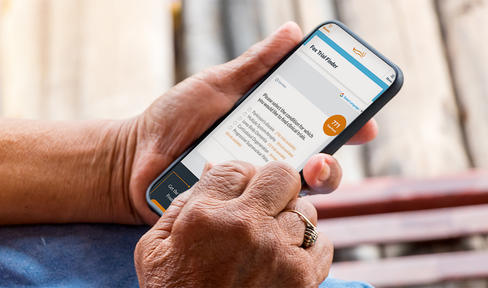 Close-up image of person holding phone and using Fox Trial Finder.