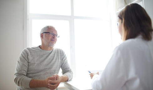 Patient speaks with doctor in an office