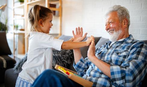 Grandfather and granddaughter laughing together