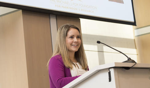 Ashley Harms, PhD, at a podium.