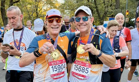 John with his 2025 NYC Marathon medal.
