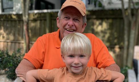 Chip holds his grandson, Teddy. 
