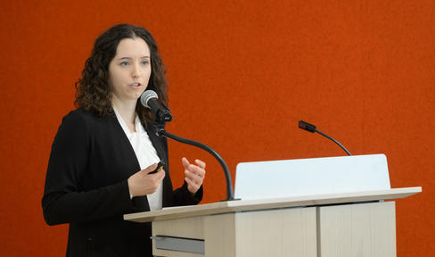 Dr. Marissa Dean speaking at a podium at the 2018 Edmond J. Safra "Fellowship Symposium Day."