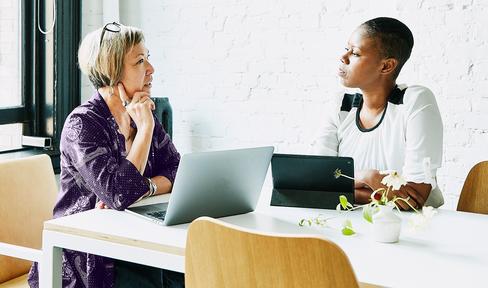 Two people discussing health care plans.