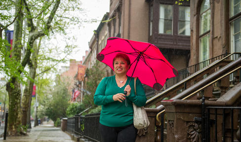 Woman walking outside holding an umbrella
