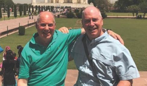 PPMI Participant Hyam Kramer and his husband Tom posing in front of the Taj Mahal on their vacation.