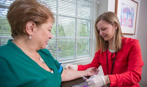Woman giving blood in a clinic.