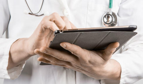 Doctor with tablet.