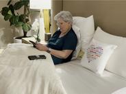 Woman laying in bed of comfort linen