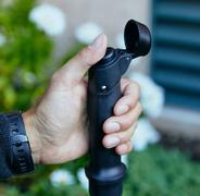 A hand gripping the Upppestate pole and adjusting the height setting