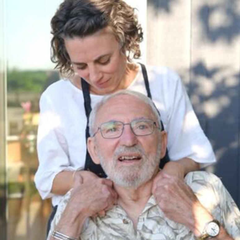 Aimie Vallat stands behind her father, Gary