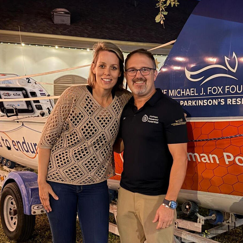 Ashley Ellis poses with Patrick Morrissey next to the HPP rowboat.