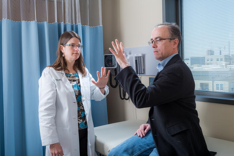 Physician and patient working through a hand movement test