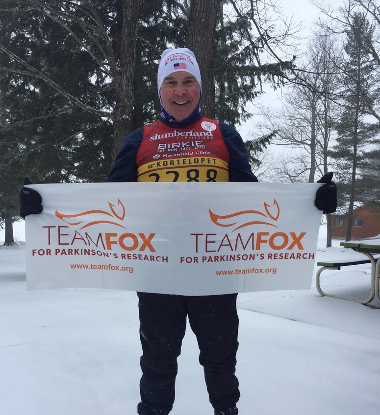 Mark Gherty holding Team Fox banner
