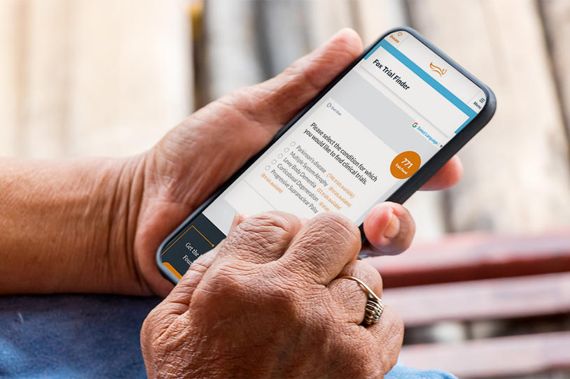 Close-up image of person holding phone and using Fox Trial Finder.