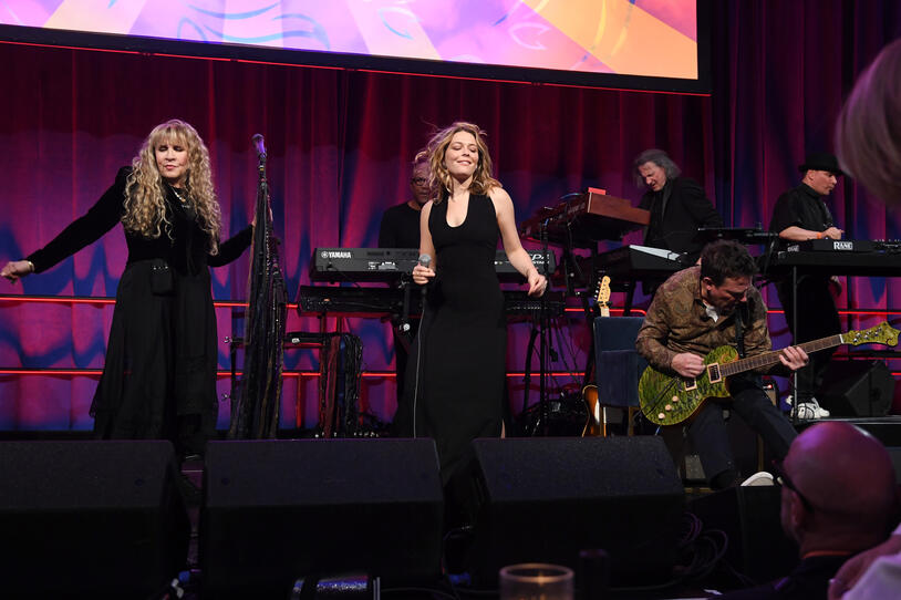 Stevie Nicks, Maggie Rogers and Michael J. Fox perform onstage.