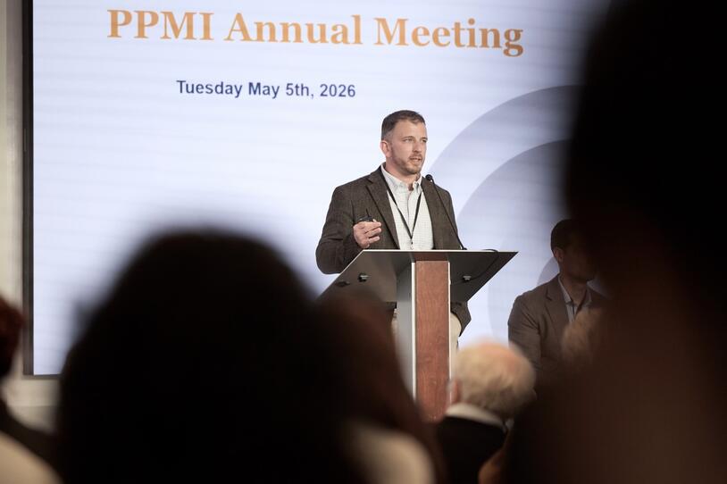 A man speaks at a podium.