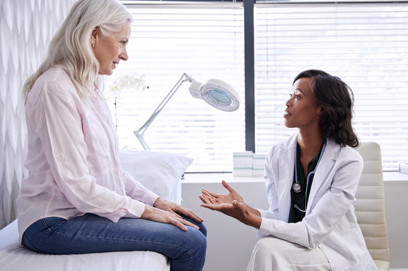 Patient on bed speaking to a doctor