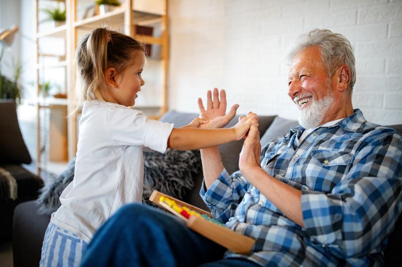 Grandfather and granddaughter laughing together