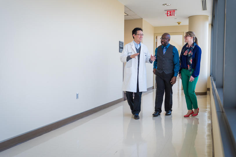 Doctor walking with patients.
